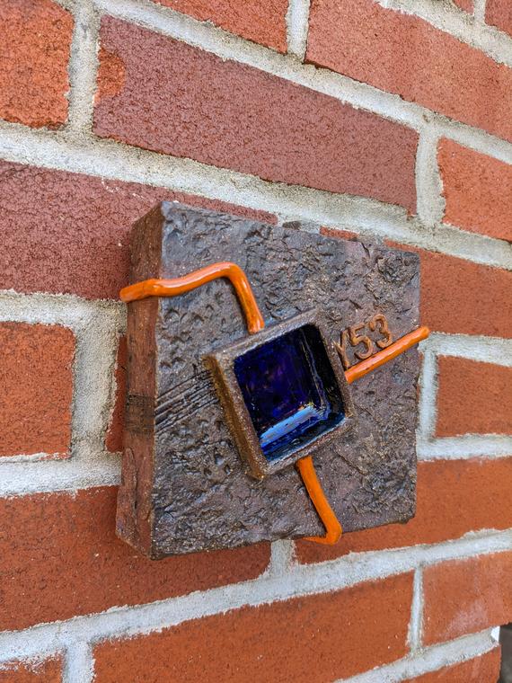 Box Tile 8 “3 Body Problem” (2024) Red stoneware, oxide washes, underglaze, glaze, upcycled glass. Electric fired. Cold worked. Wall piece.